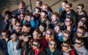 Schüler der Astronomiekurse der Wöhlerschule in Frankfurt am Main verfolgen gebannt die Sonnenfinsternis. Foto: dpa